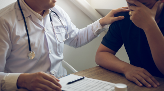 Doctor comforting patient